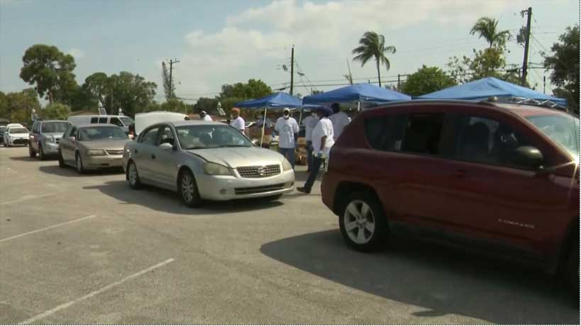 Row of cars waits for a Feeding South Florida food distribution