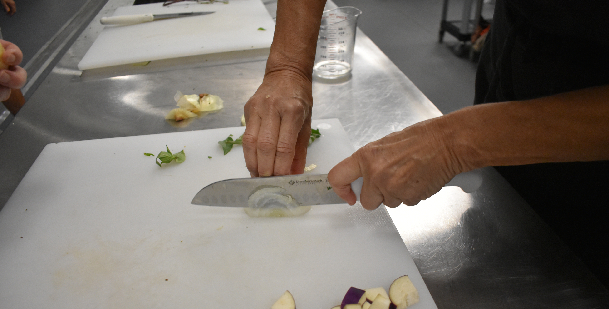 Knife Skills on an Onion at Feeding South Florida Cooking Classes