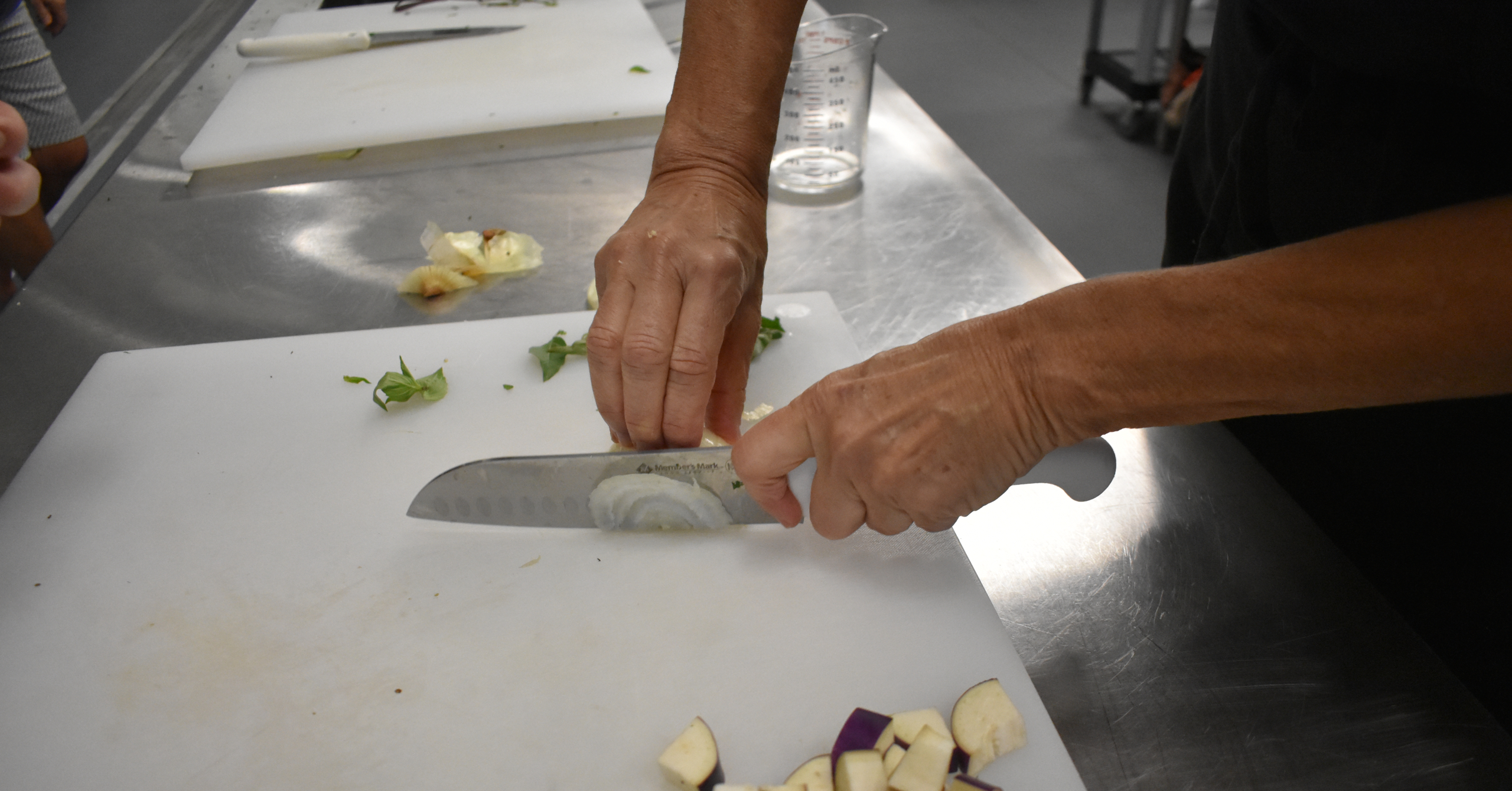 Knife Skills on an Onion at Feeding South Florida Cooking Classes - Proper Knife Technique